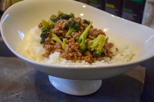 A bowl filled with rice, tender meat, and vibrant broccoli, creating a colorful and appetizing meal.