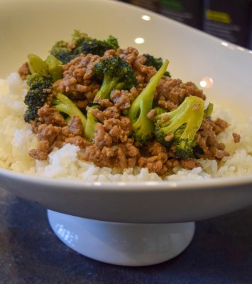 A bowl filled with rice, tender meat, and vibrant broccoli, creating a colorful and appetizing meal.