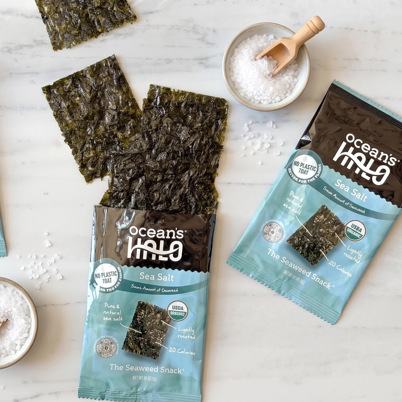 Ocean's Halo Sea Salt seaweed snack packages with crispy roasted seaweed sheets and bowls of coarse sea salt.