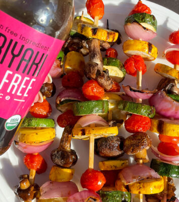 A colorful plate featuring an assortment of fresh vegetables arranged on skewers.