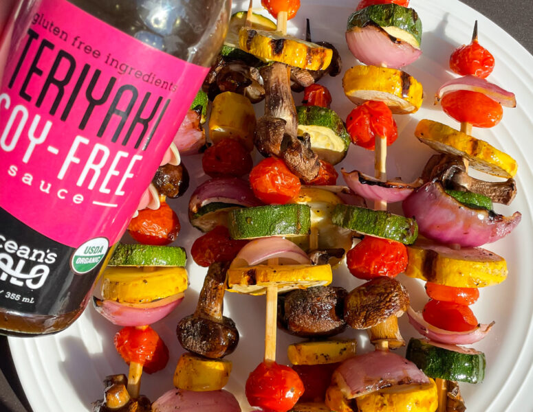 A colorful plate featuring an assortment of fresh vegetables arranged on skewers.