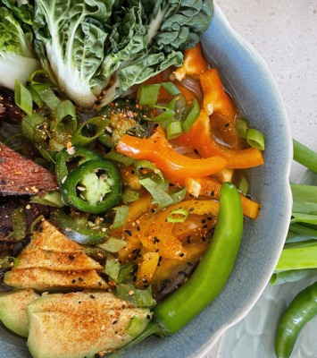 A bowl filled with colorful vegetables and tender pieces of meat, showcasing a nutritious meal.
