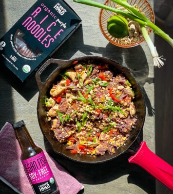 A skillet filled with sizzling meat and colorful vegetables, ready to be served.