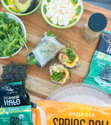 A feta egg breakfast wraps on a cutting board with Ocean’s Halo Spring roll wraps, Wasabi Seaweed and Shichimi Togarashi.
