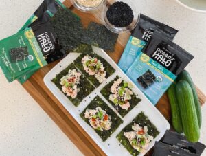 A plate of Seaweed Snacks with tuna, green onions, hot sauce with Ocean’s Halo Seaweed Snacks next to it