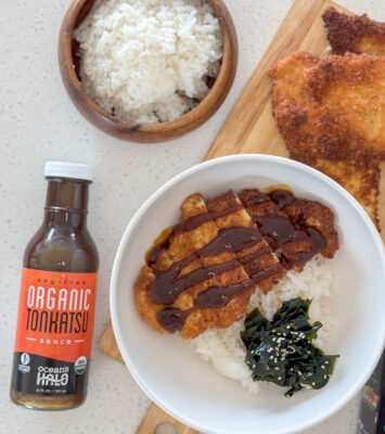 A bowl of Chicken Katsu over rice with Ocean’s Halo Organic Tonkatsu Sauce next to it